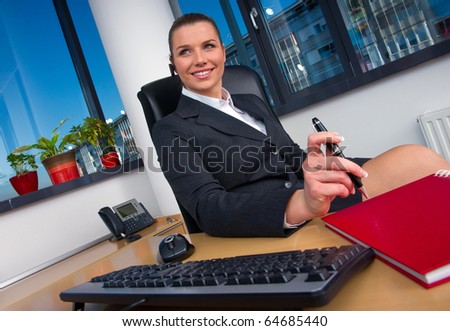 business woman with wireless headset at office desk