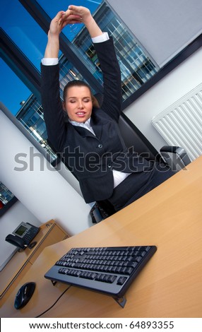 business woman stretching at office table