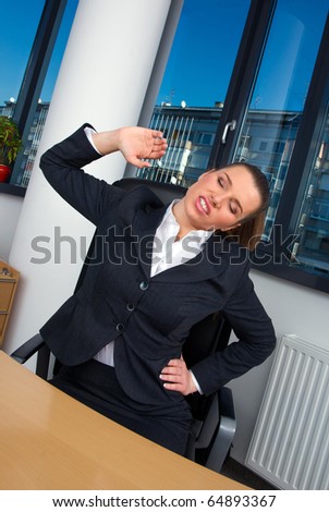 business woman stretching at office desk