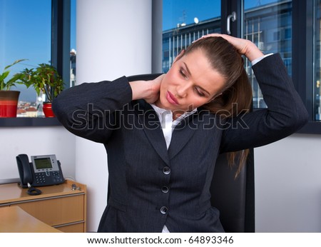business woman with head and neck pain in office