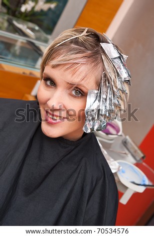 dark hair with foils. foil on her hair in salon