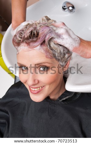 woman washing hair in salon