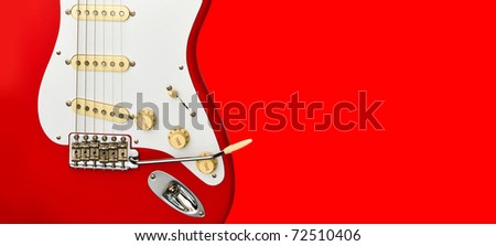 red electric guitar detail on red background