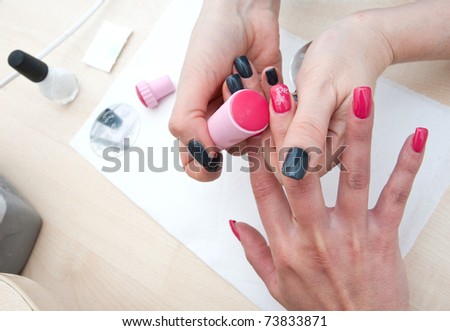 stylist stamping woman finger nails , nailart