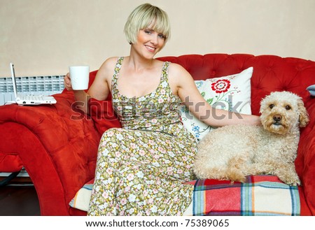 woman and dog sitting on the sofa in living room