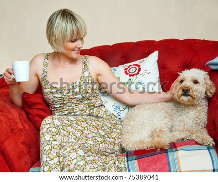 woman and dog sitting on the sofa in living room