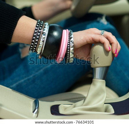 woman hand changing gear in the car