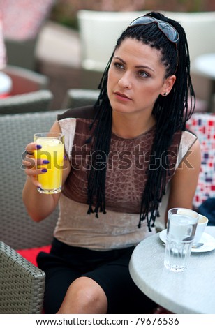 woman with orange juice in outside bar