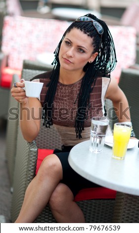 woman with coffee in outside bar terrace