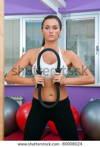 fit woman in fitness salon exercise with pilates magic circle