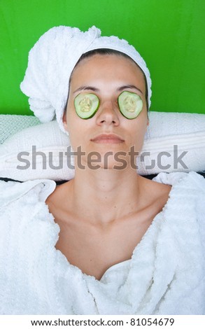 woman face with no make up in treatment cucumber mask on her eyes
