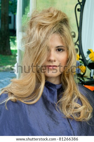 beautiful woman with messy hair waiting in hair salon