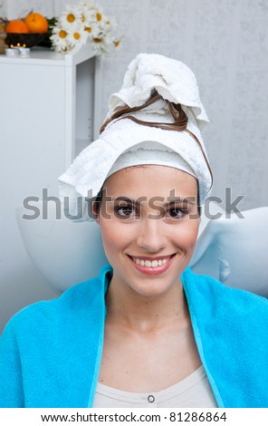 woman in hair salon with wet hair and towel on the head