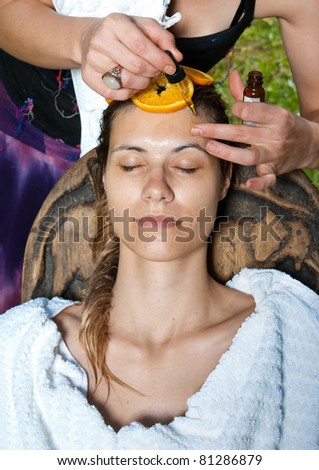 attractive woman having natural oil facial treatment