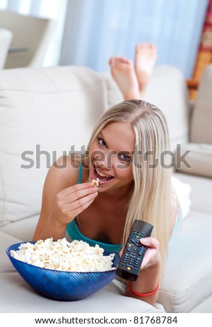 attractive woman with remote controller and popcorn
