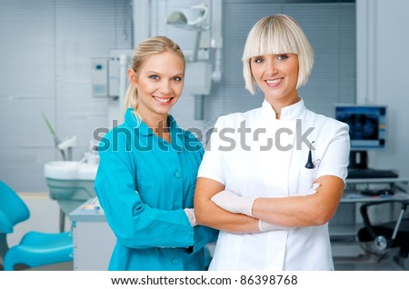 woman dentist standing in office with her personal assistant