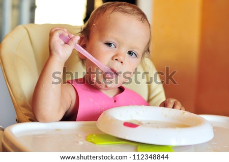 funny eating baby girl with dirty face
