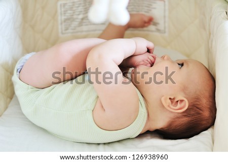 baby with feet in mouth