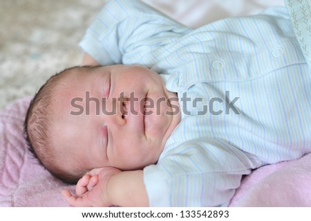 funny newborn slugging on the sunny side of bed
