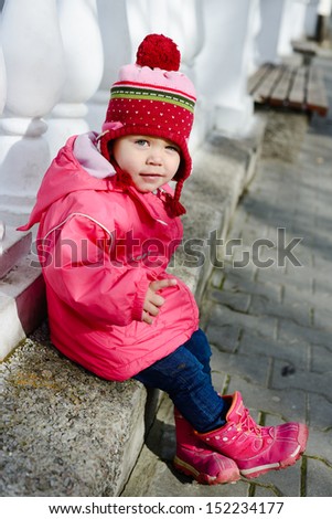 funny winter toddler girl point with finger
