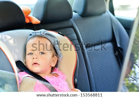 baby girl sitting in car