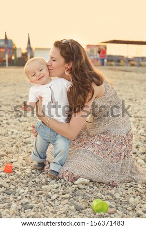 mother kissing happy baby son