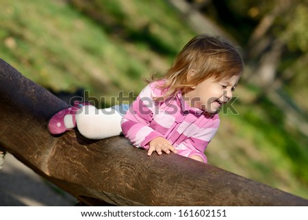 laughing toddler climbing  on the walk