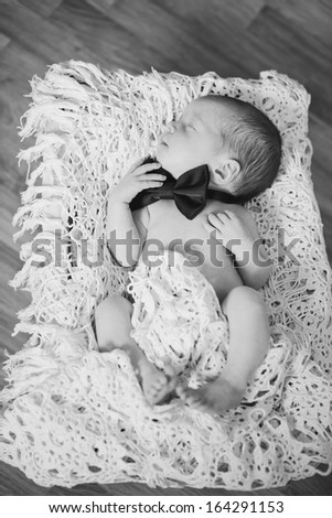 newborn boy wearing bow tie in black and white