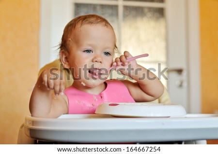eating baby with spoon in mouth