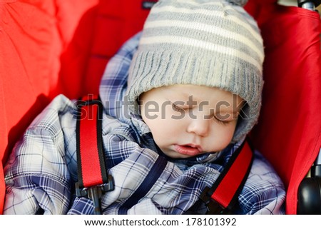 baby boy sleeping in the stroller