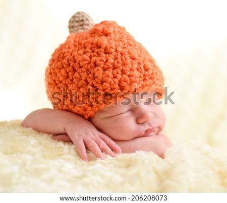sweet newborn wearing orange hat