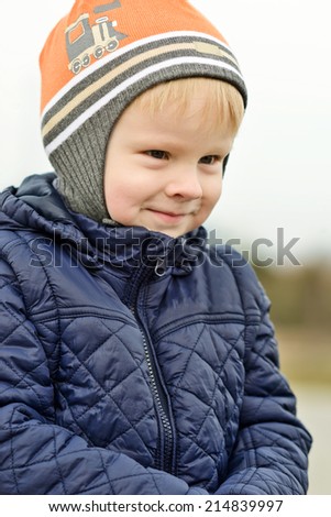 toddler boy outdoors with cunning face