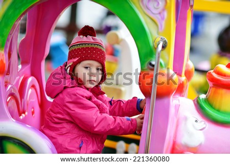 baby girl driving a train in theme park