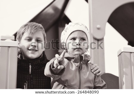happy brother and sister on the playground