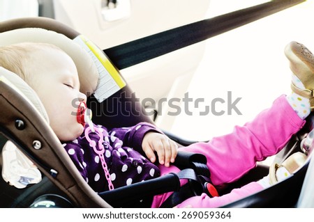 baby girl sleeping in the car seat
