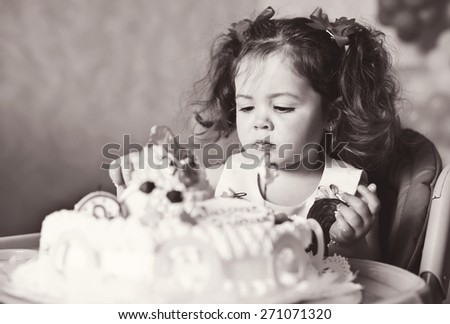 cute toddler girl  with her  birthday  cake