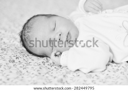 sleeping sweet newborn girl on the bed