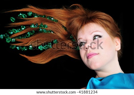 head of girl with natural red hair over black.