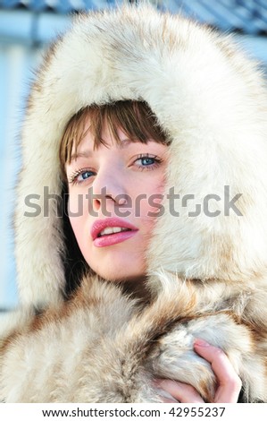 Beautiful tender woman wearing fur hat and furs