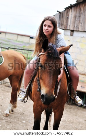 stock photo teen longhaired girl sitting on the horse