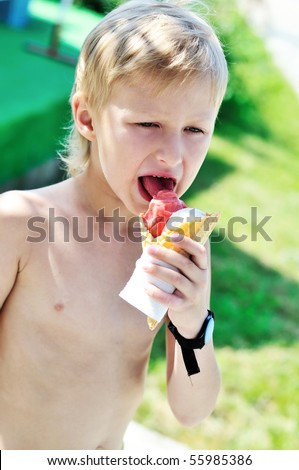 little boy enjoying sweet ice cream near pool
