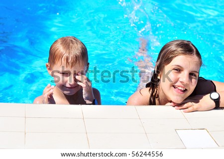 brother and sister having good time in the pool