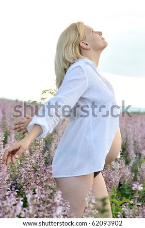 togetherness with nature- pregnant woman  pulling towards sun