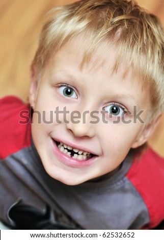 little boy showing that he lost first milk tooth