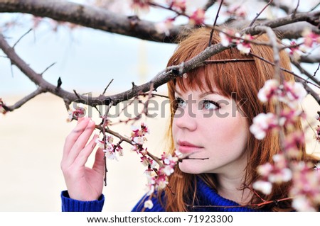 redheaded girl smelling blossom of <b>peach tree</b> - stock-photo-redheaded-girl-smelling-blossom-of-peach-tree-71923300