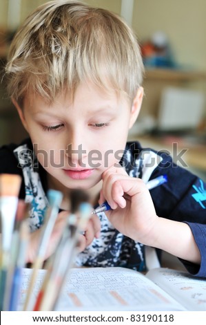 left-handed boy doing a home task at home
