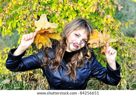 funny teen girl with autumn leaves