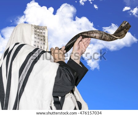 Man blowing Shofar horn for the Jewish New Year holiday (Rosh Hashanah)/Shofar to the sky/ Man blowing Shofar horn for the Jewish New Year holiday (Rosh Hashanah)