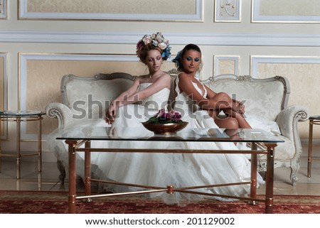 Lovely brides in a reception hotel having a large flowers bun hair.