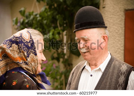 Portrait of a very old couple at country side smiling and having fun. See more images with them.
